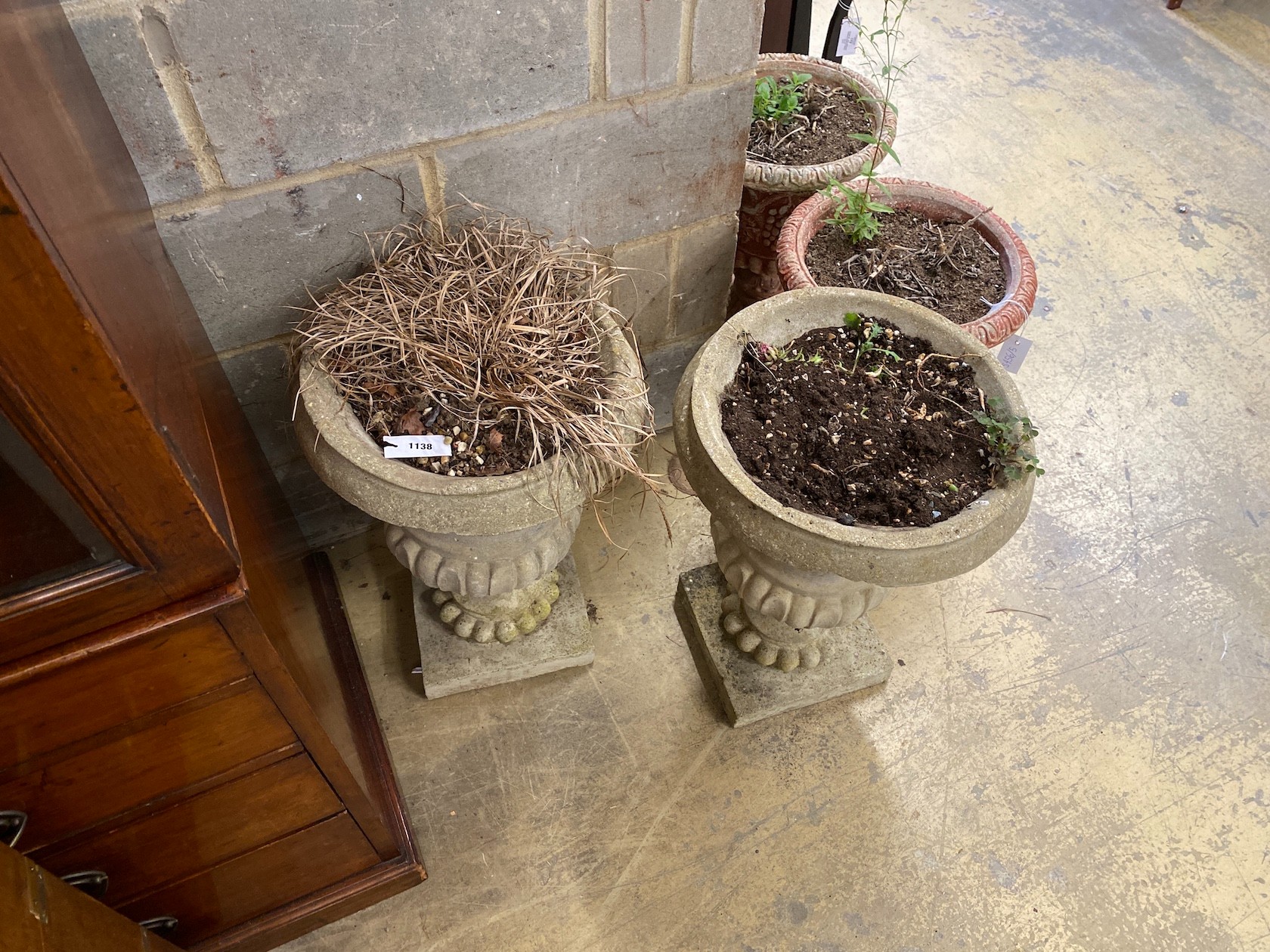 A pair of reconstituted stone campana garden urns, diameter 41cm, height 56cm